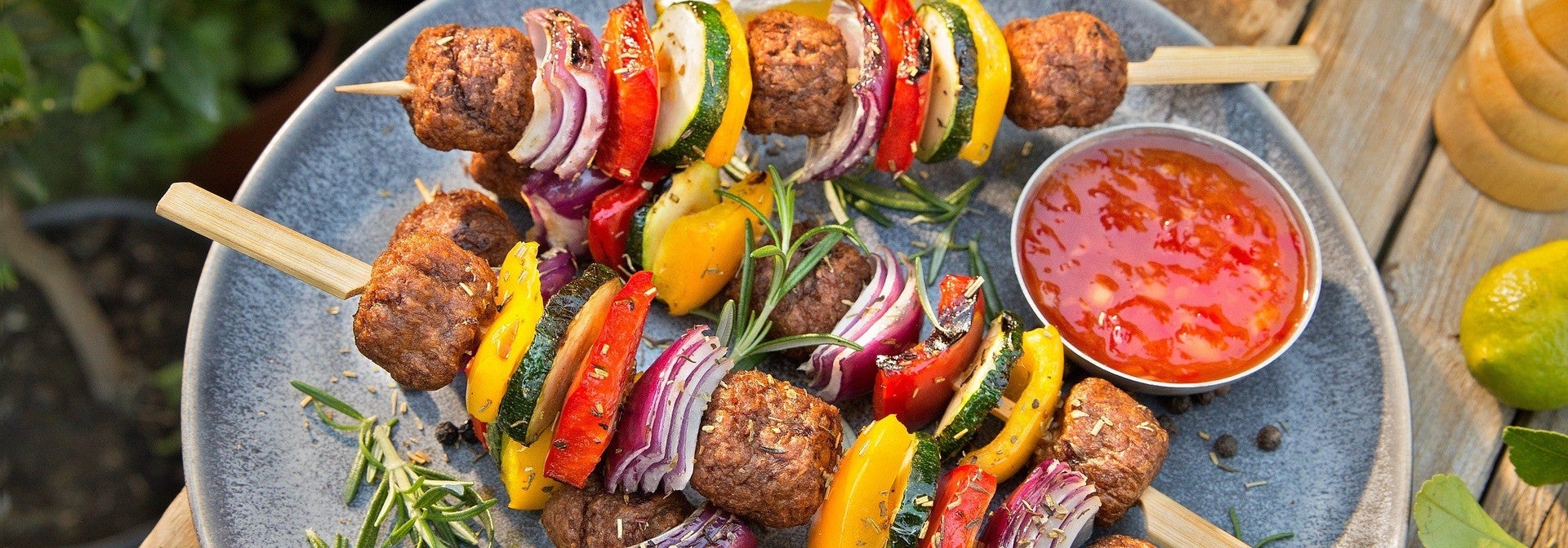 Vegan balls skewers with vegetables served with sauce and fresh rosemary