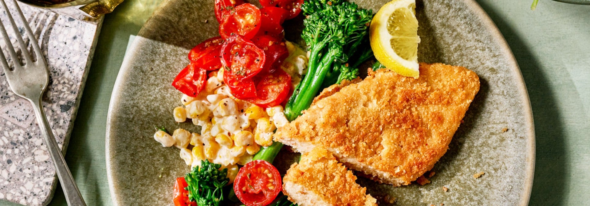 Vegan Schnitzel with Creamed Corn, Fried Cherry Tomatoes, and Broccolini