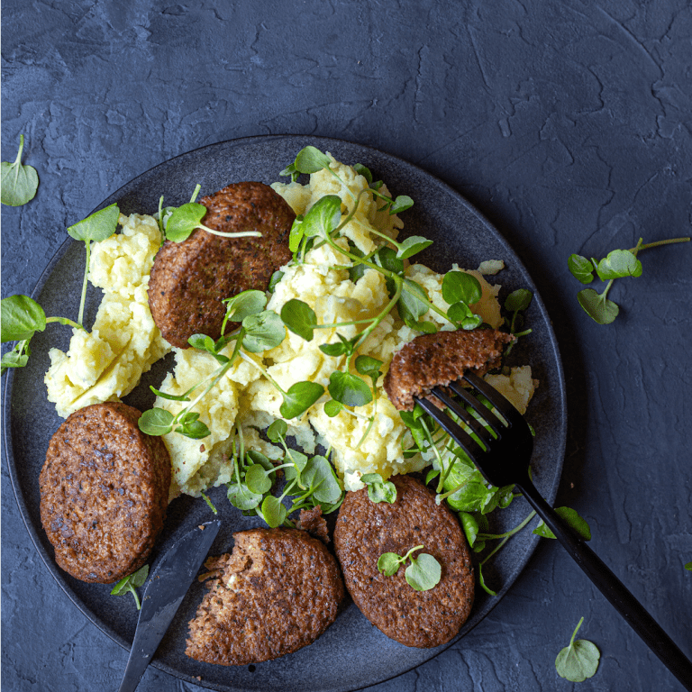 Deluxe burger with mashed potatoes and watercress